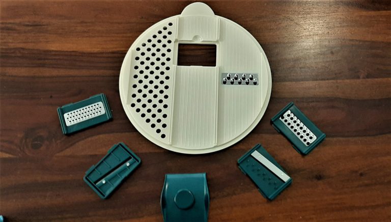 The grating and slicing attachments with the white plate